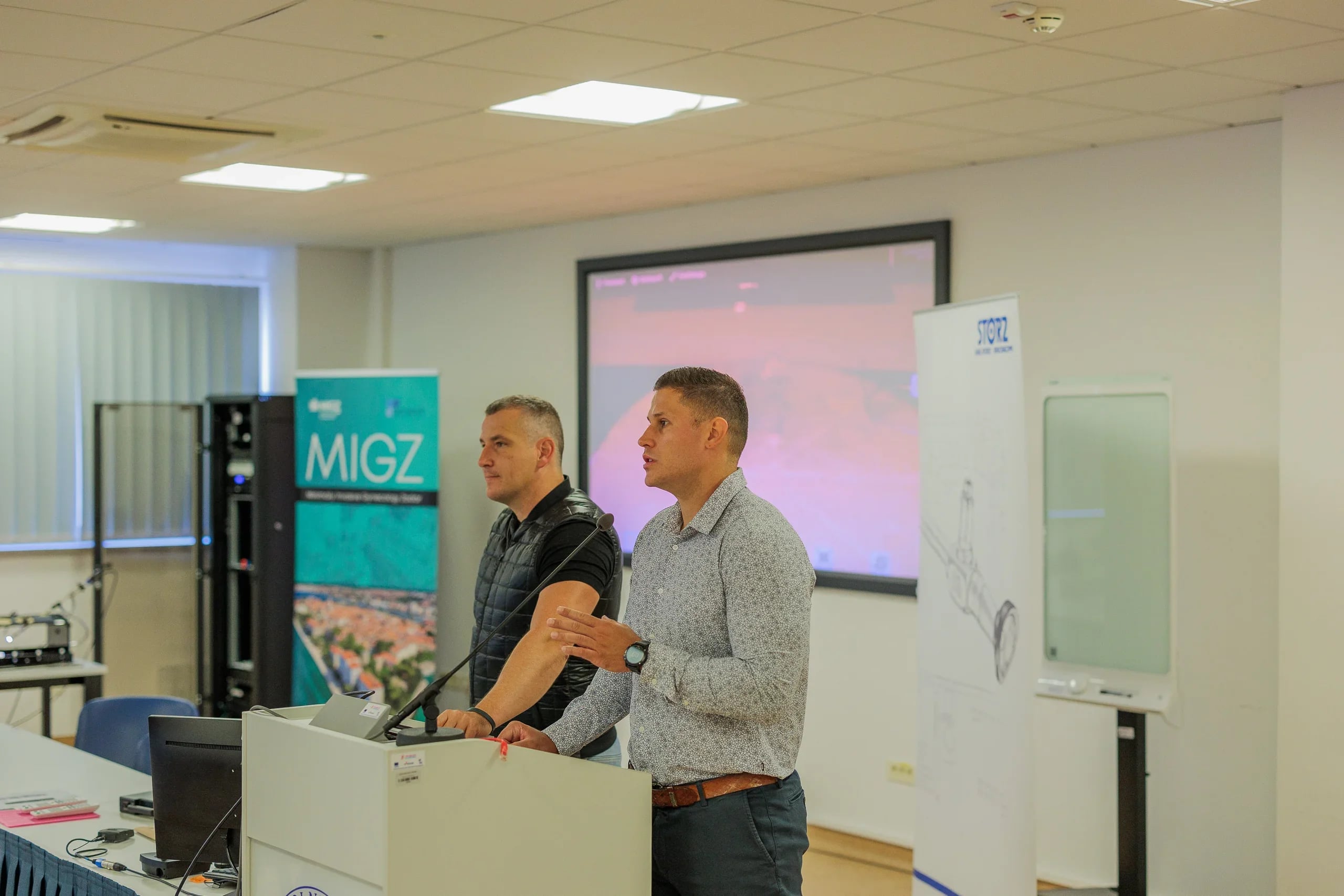 MIGZ founders speaking at a lectern