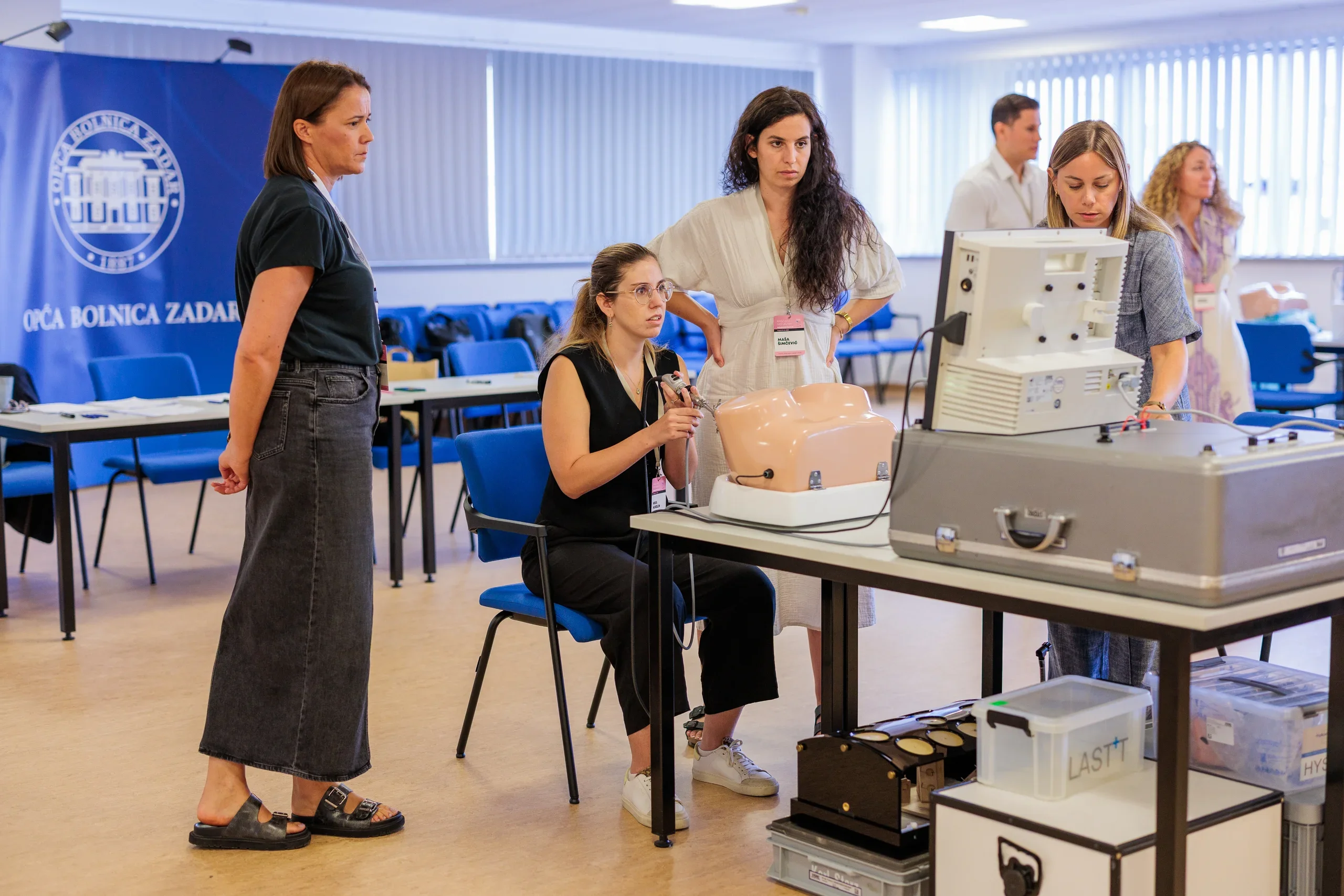 Instructor assessing a participant during surgical training